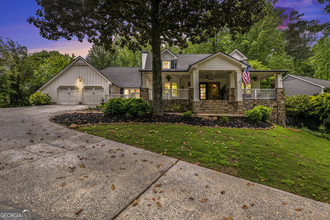 a front view of a house with a yard and green space