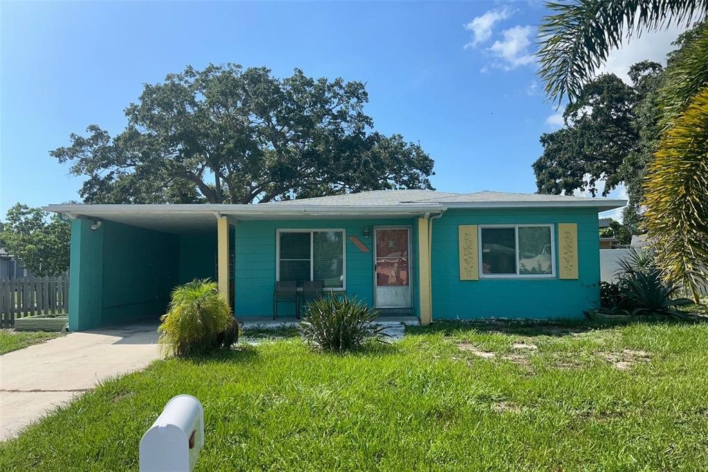 a house that has a tree in front of it