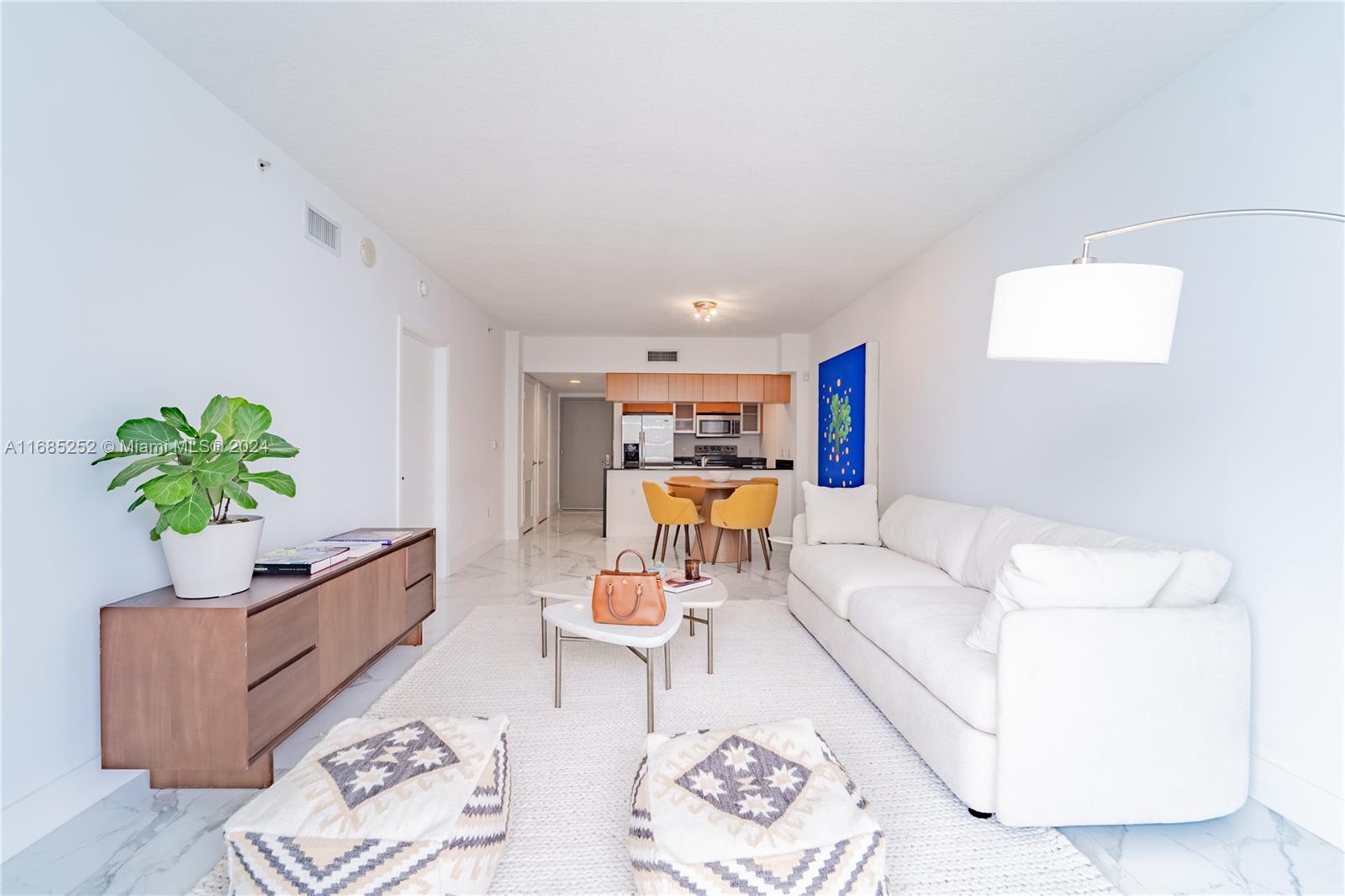 a living room with furniture and a potted plant