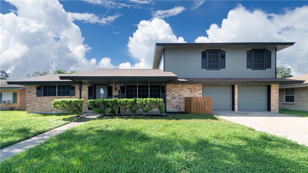 a front view of a house with a yard and garage