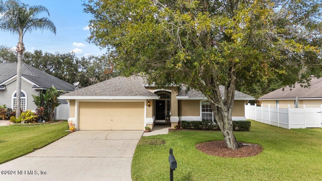 a front view of a house with a yard garage and outdoor seating