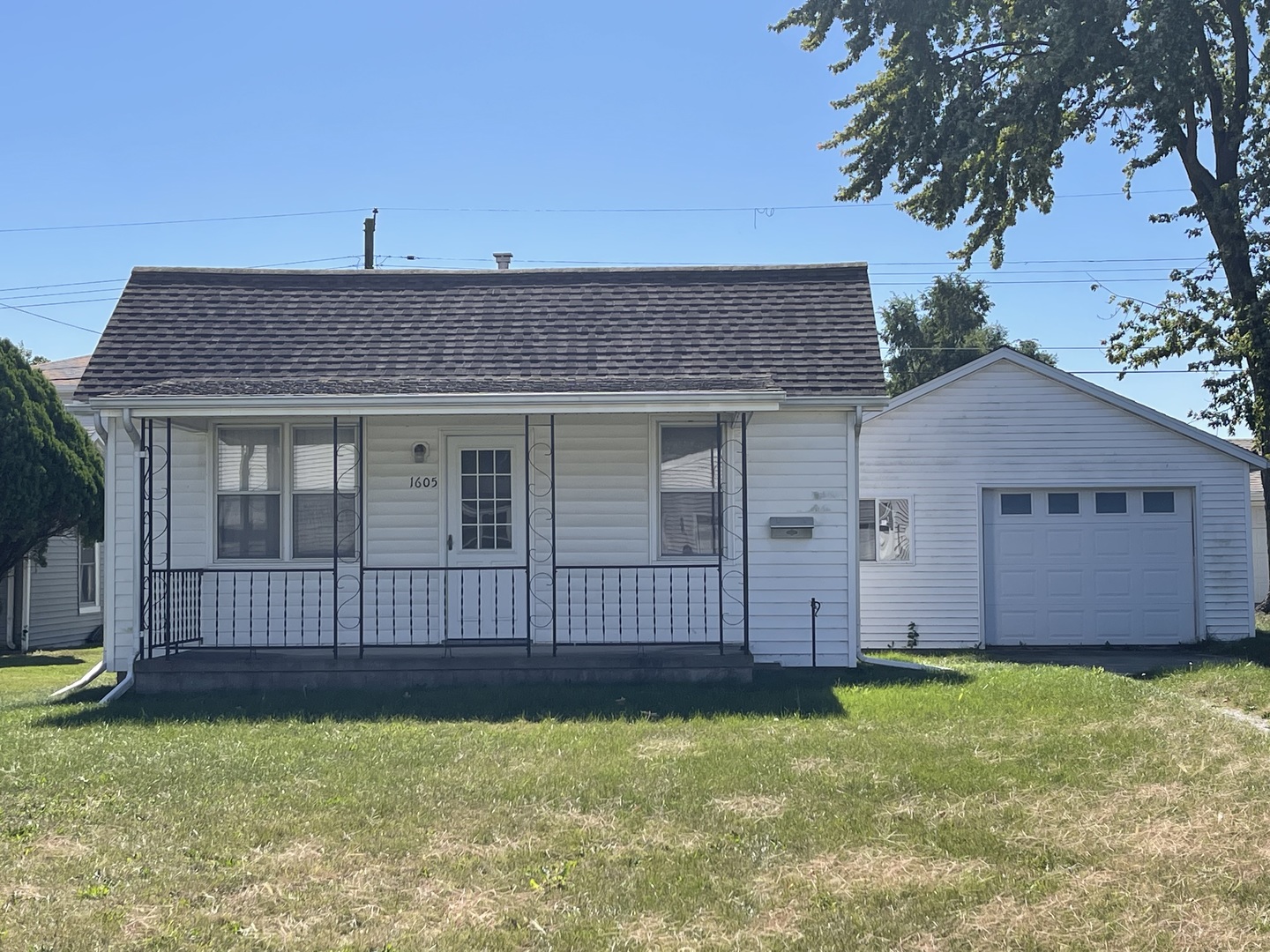 a view of a house with a yard and wooden fence