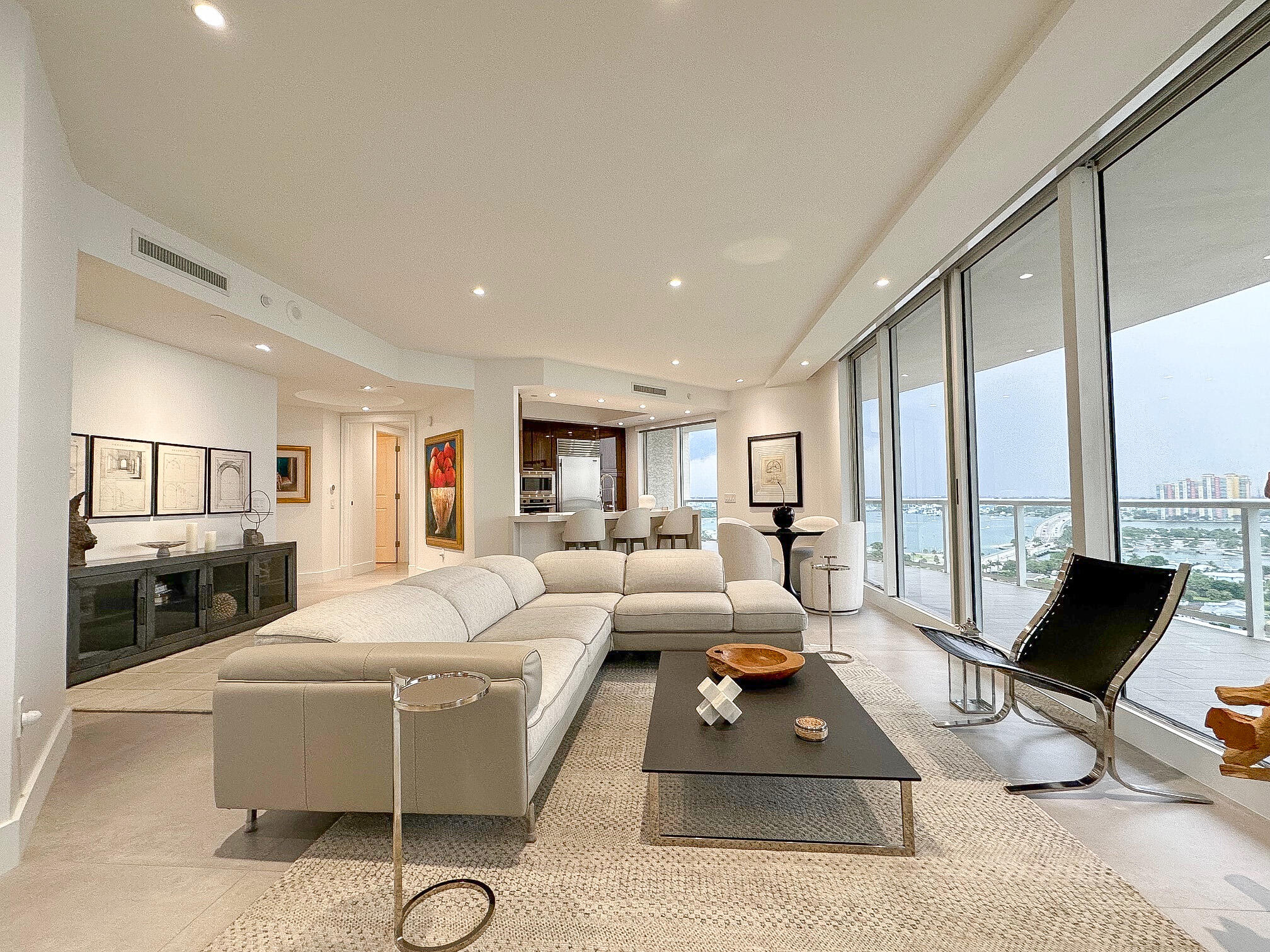 a living room with furniture rug and a floor to ceiling window