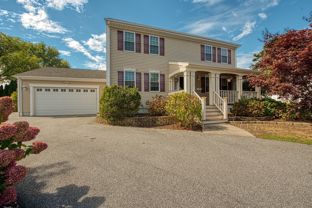 a front view of a house with a yard and a garage