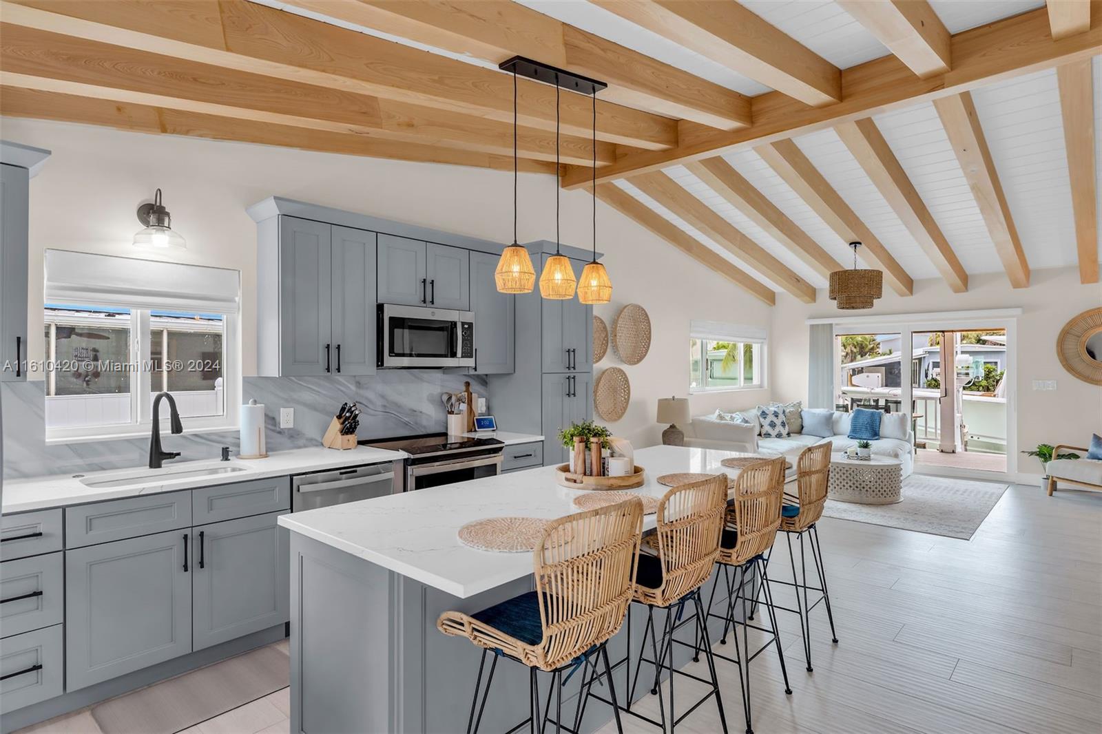 a kitchen with a dining table chairs sink and cabinets