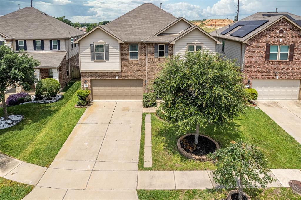 a aerial view of a house with yard