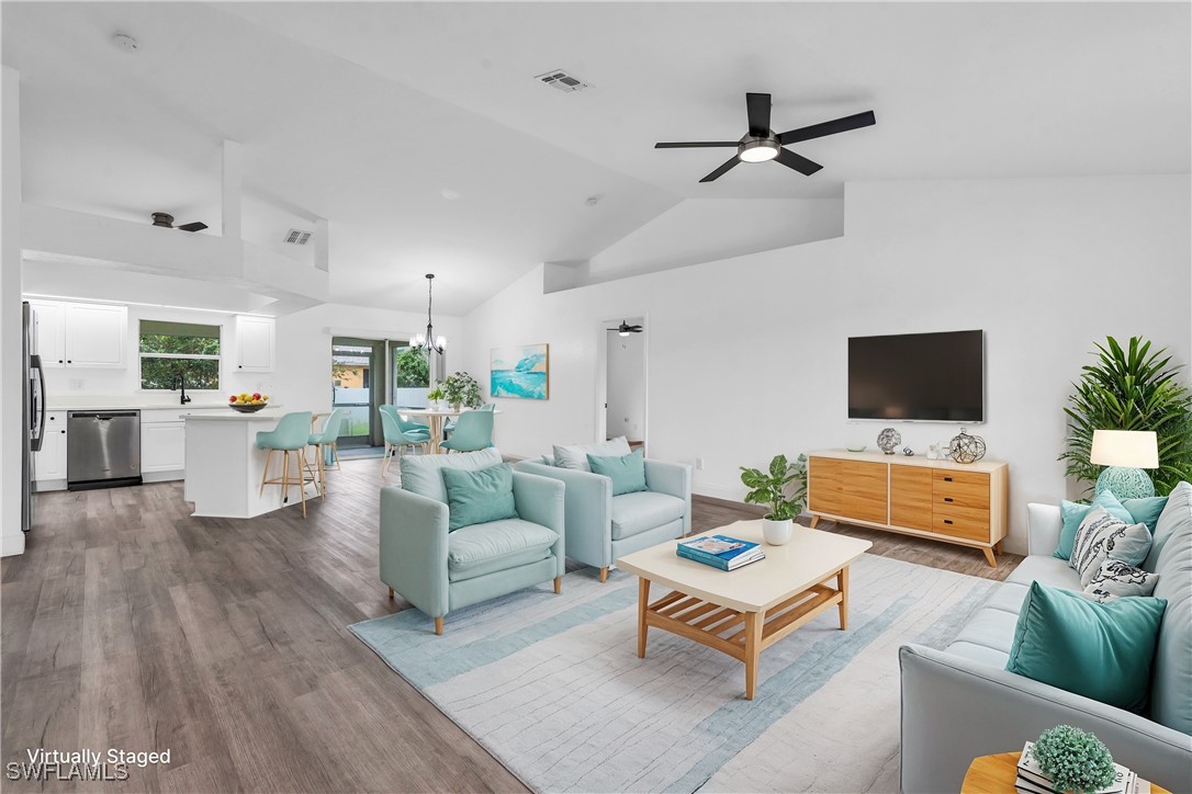 a living room with furniture and view of kitchen