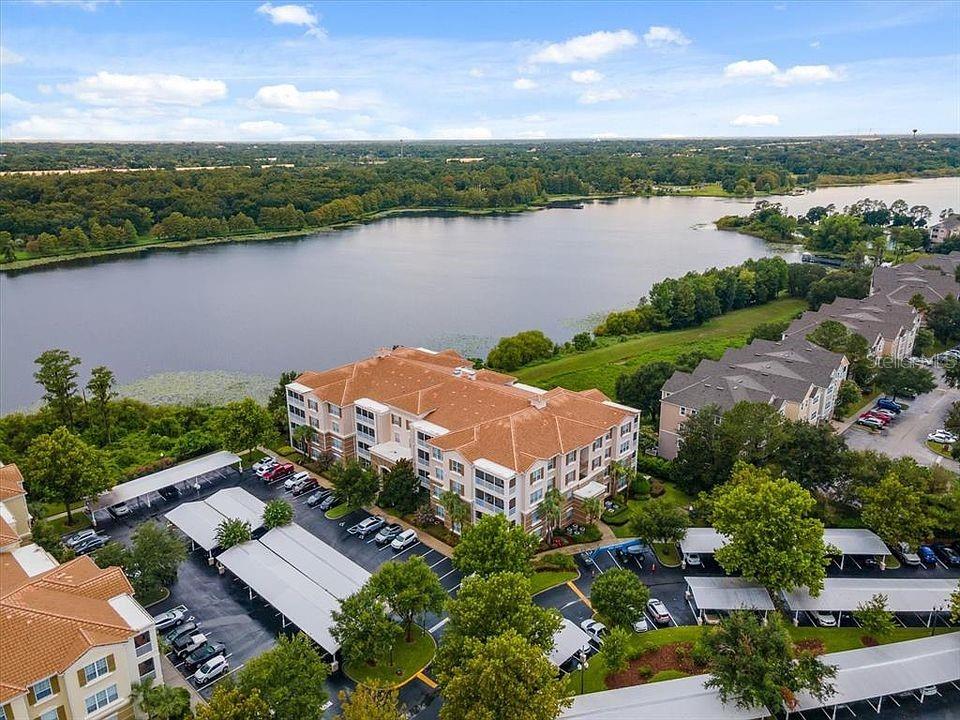 an aerial view of a house with garden space and lake view