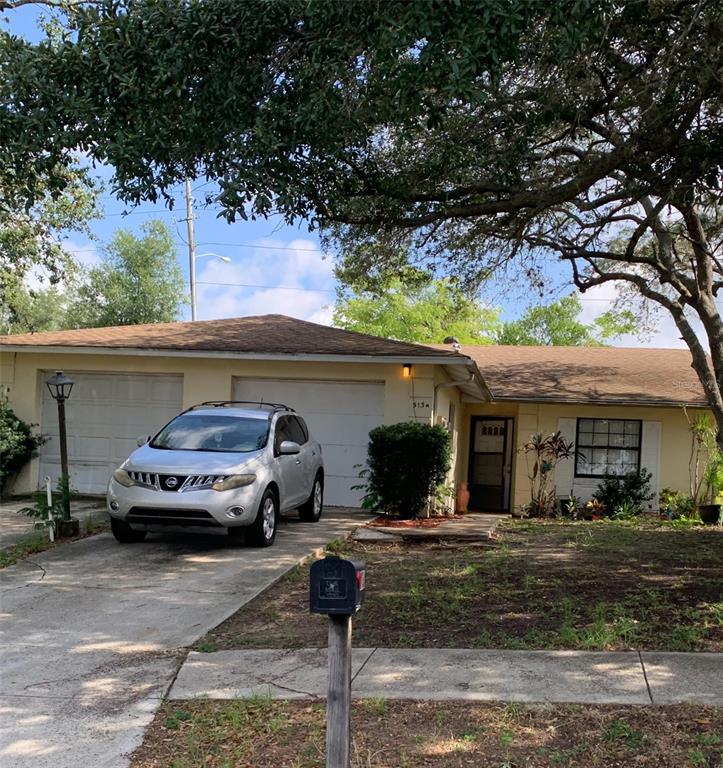 a view of a car parked front of a house