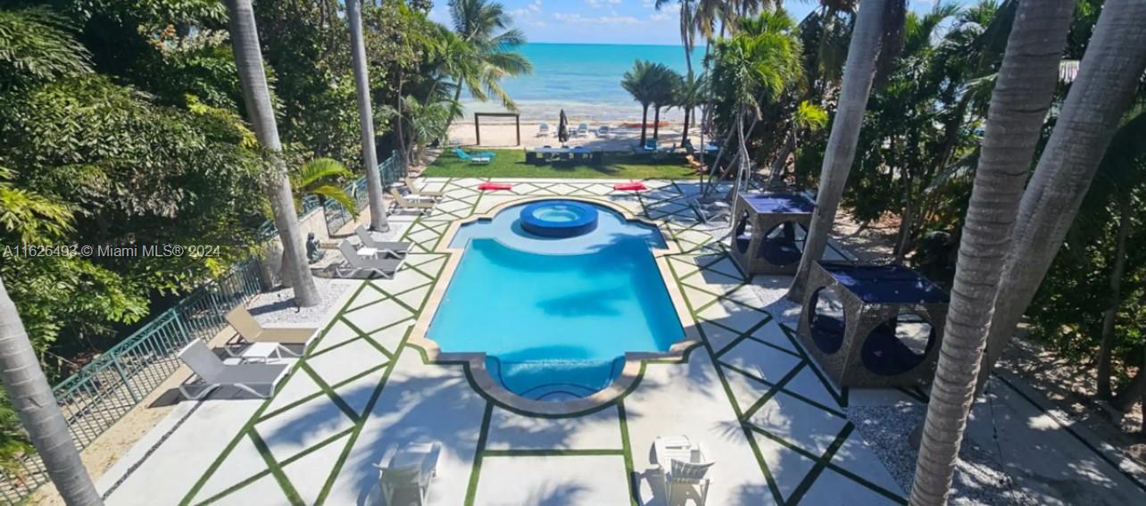 a view of a swimming pool with lounge chair