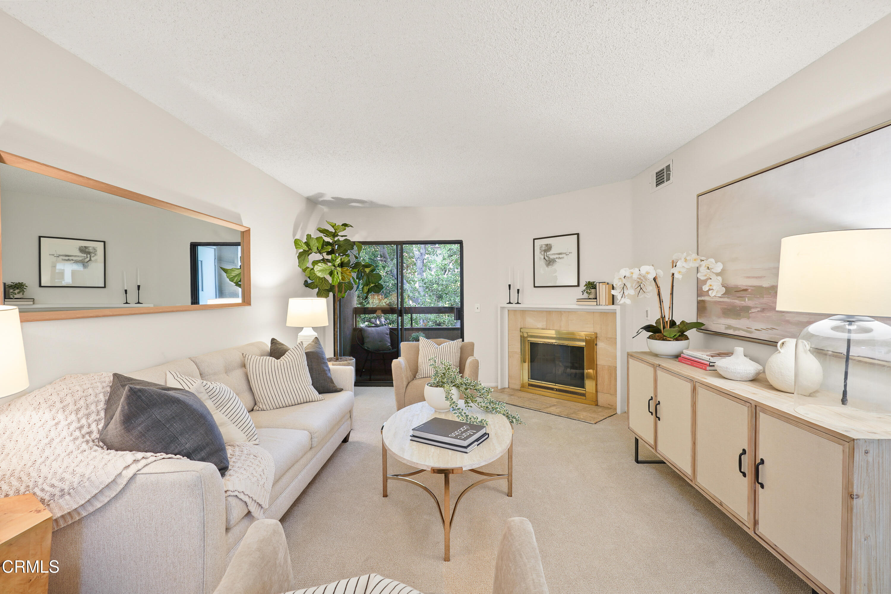 a living room with furniture a fireplace and a lamp