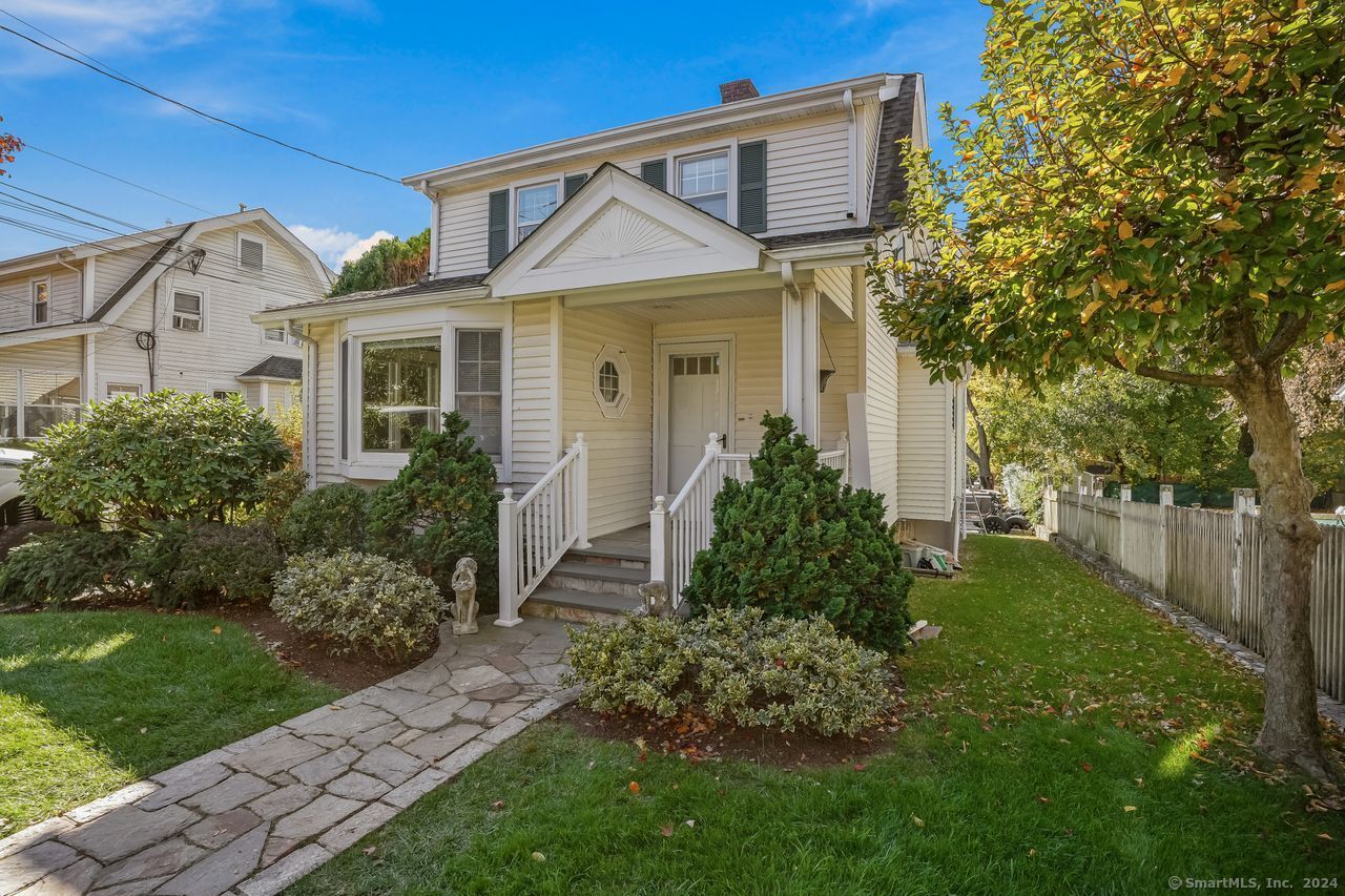 a front view of a house with garden