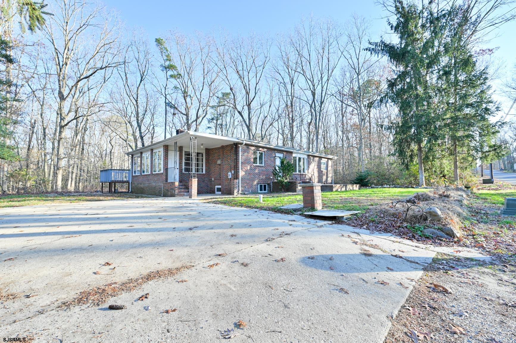 a view of a house with large trees and a big yard