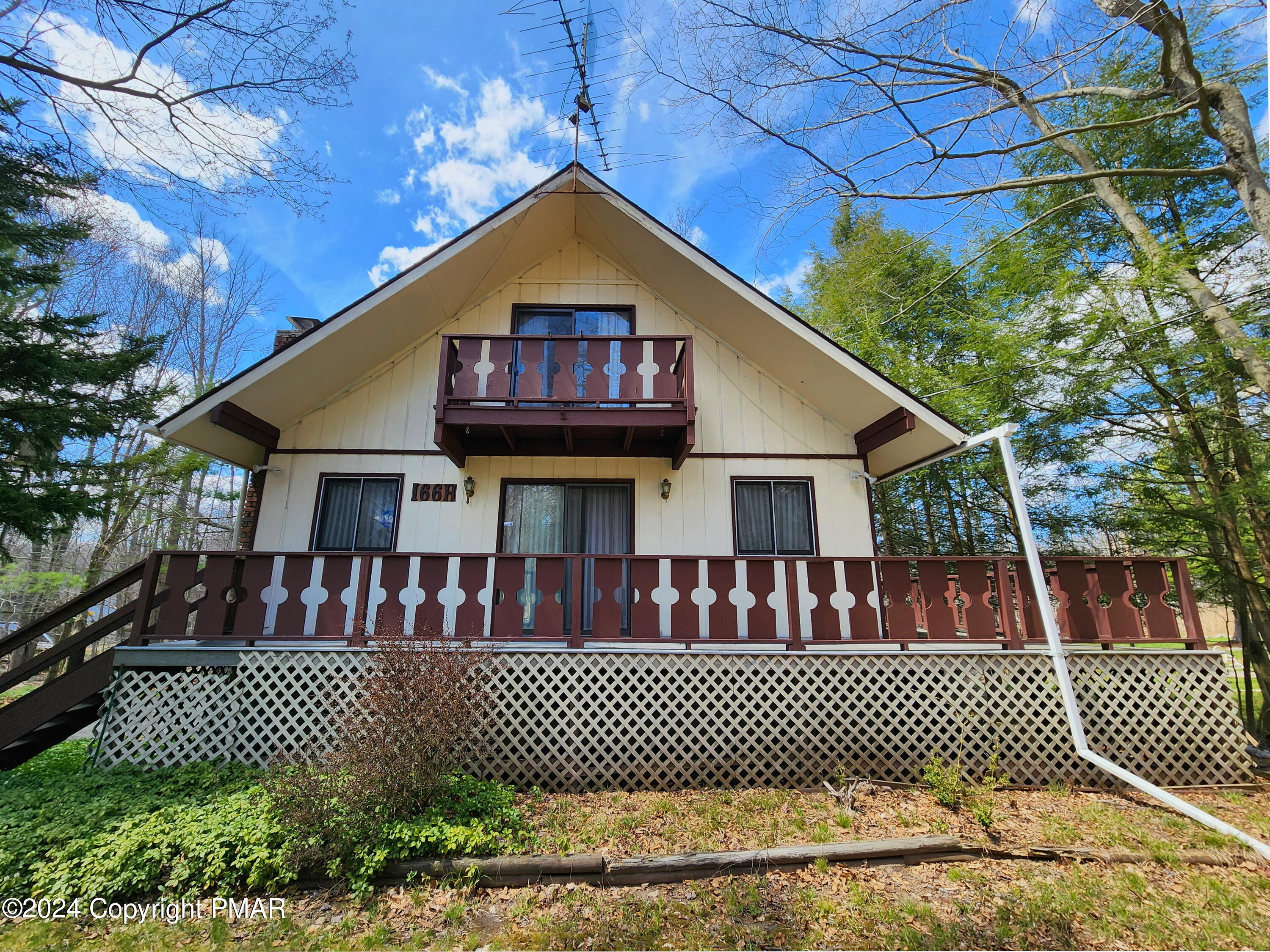 a view of a brick house with a deck