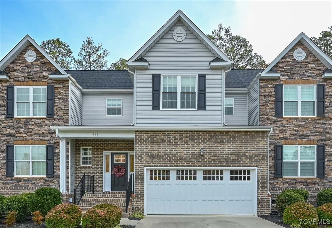 Front of home with low-maintenance brick and vinyl