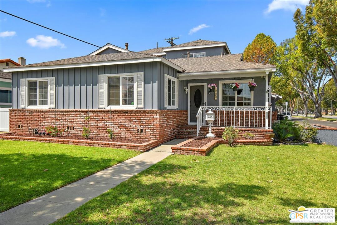 a view of a house with a yard patio and a small yard