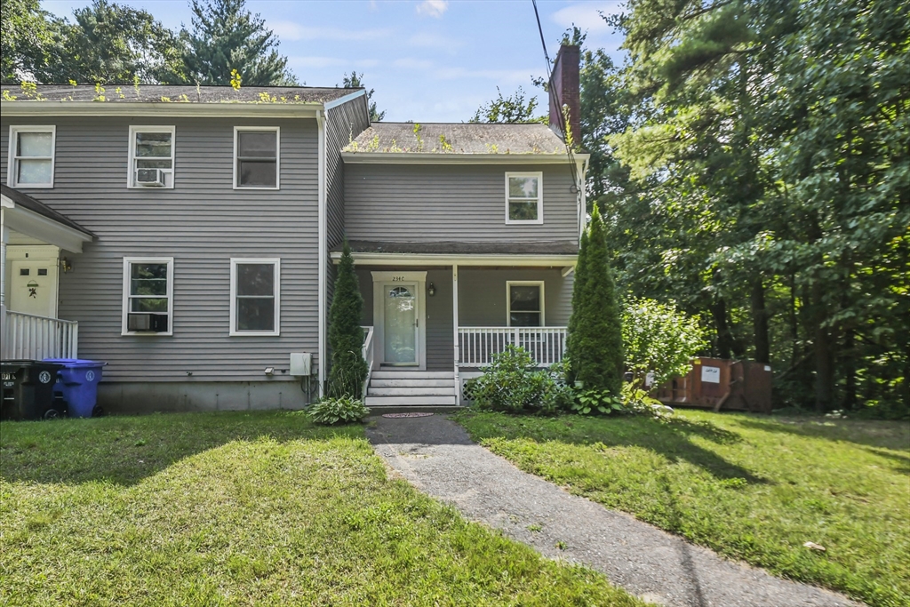 a view of a house with a yard and plants