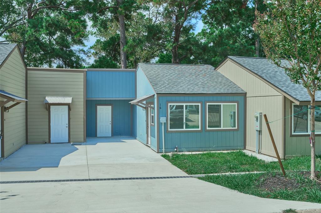 a front view of a house with a garden and yard