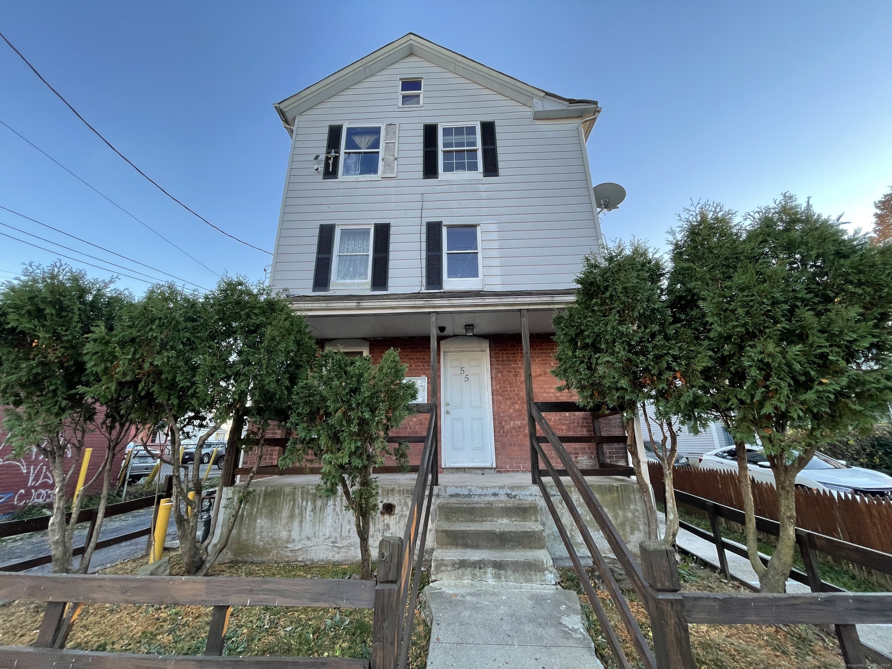 a front view of a house with chairs