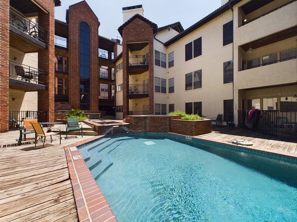 a view of a house with swimming pool and sitting area