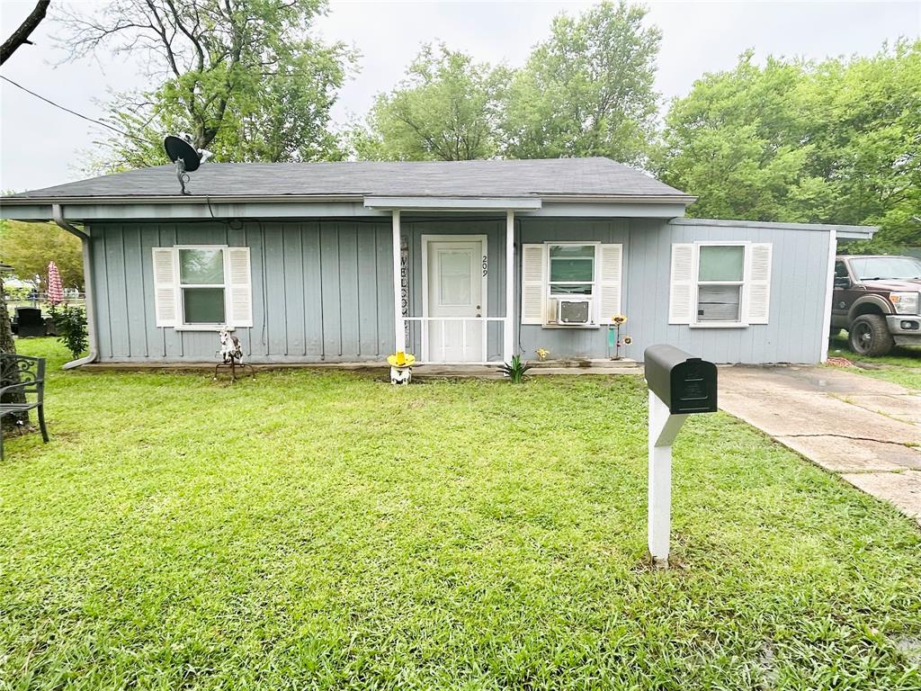 a front view of a house with a yard and porch