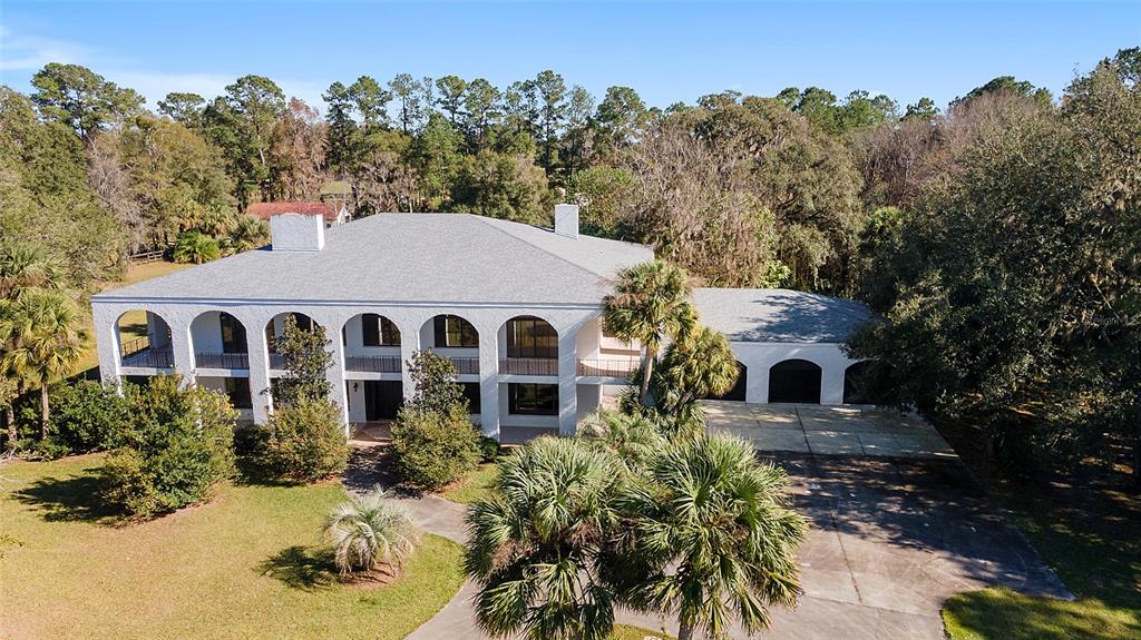 a aerial view of a house with a yard and potted plants