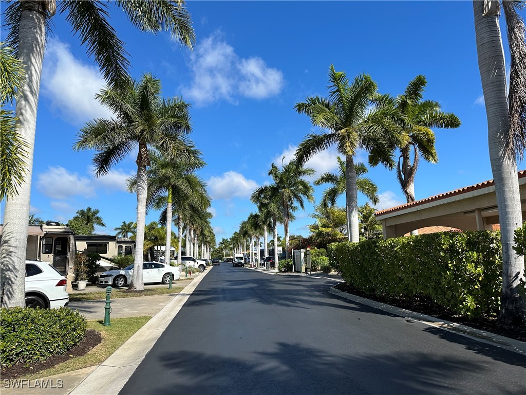 a view of multiple houses with palm trees