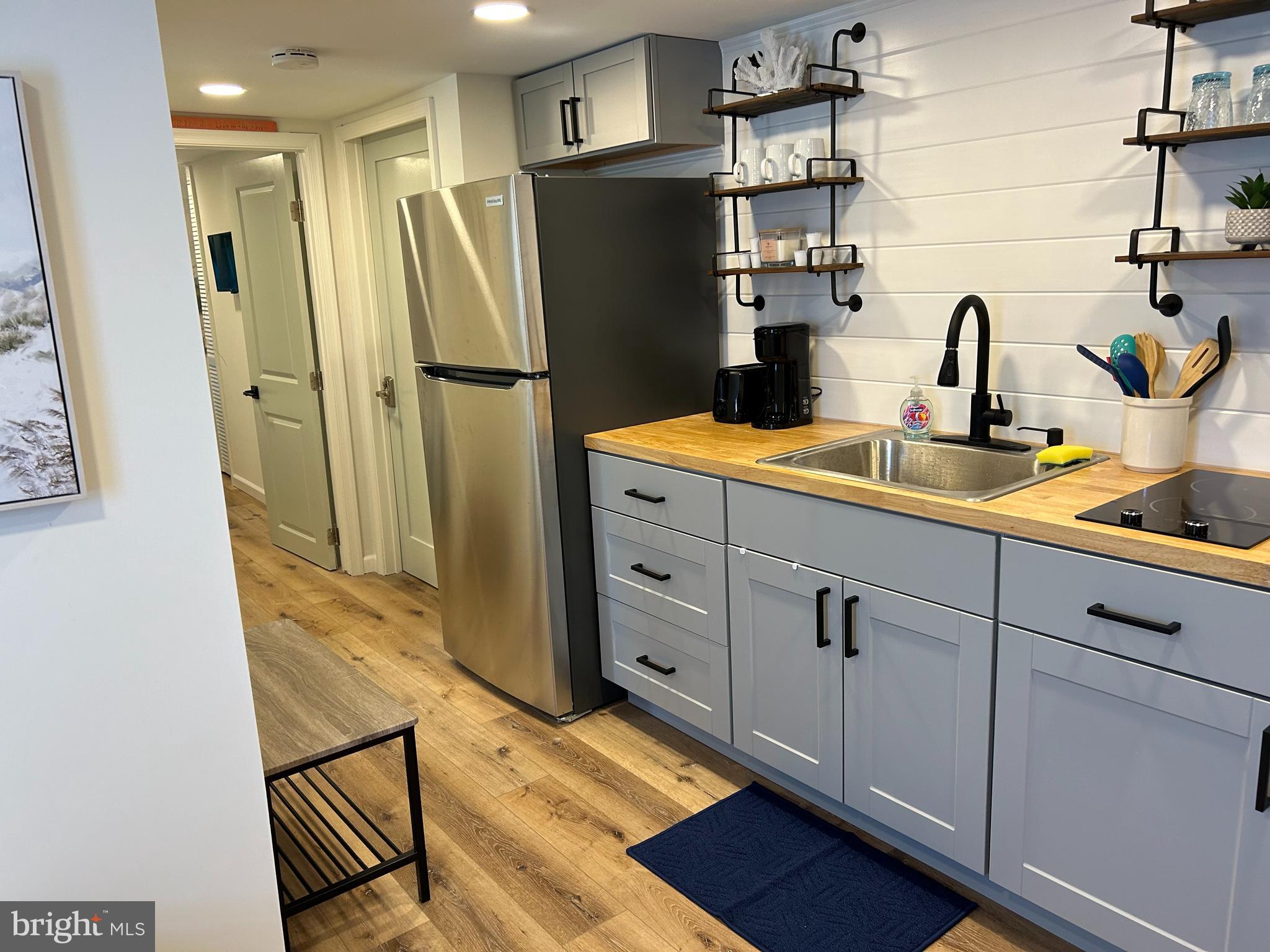 a kitchen with a refrigerator and a sink