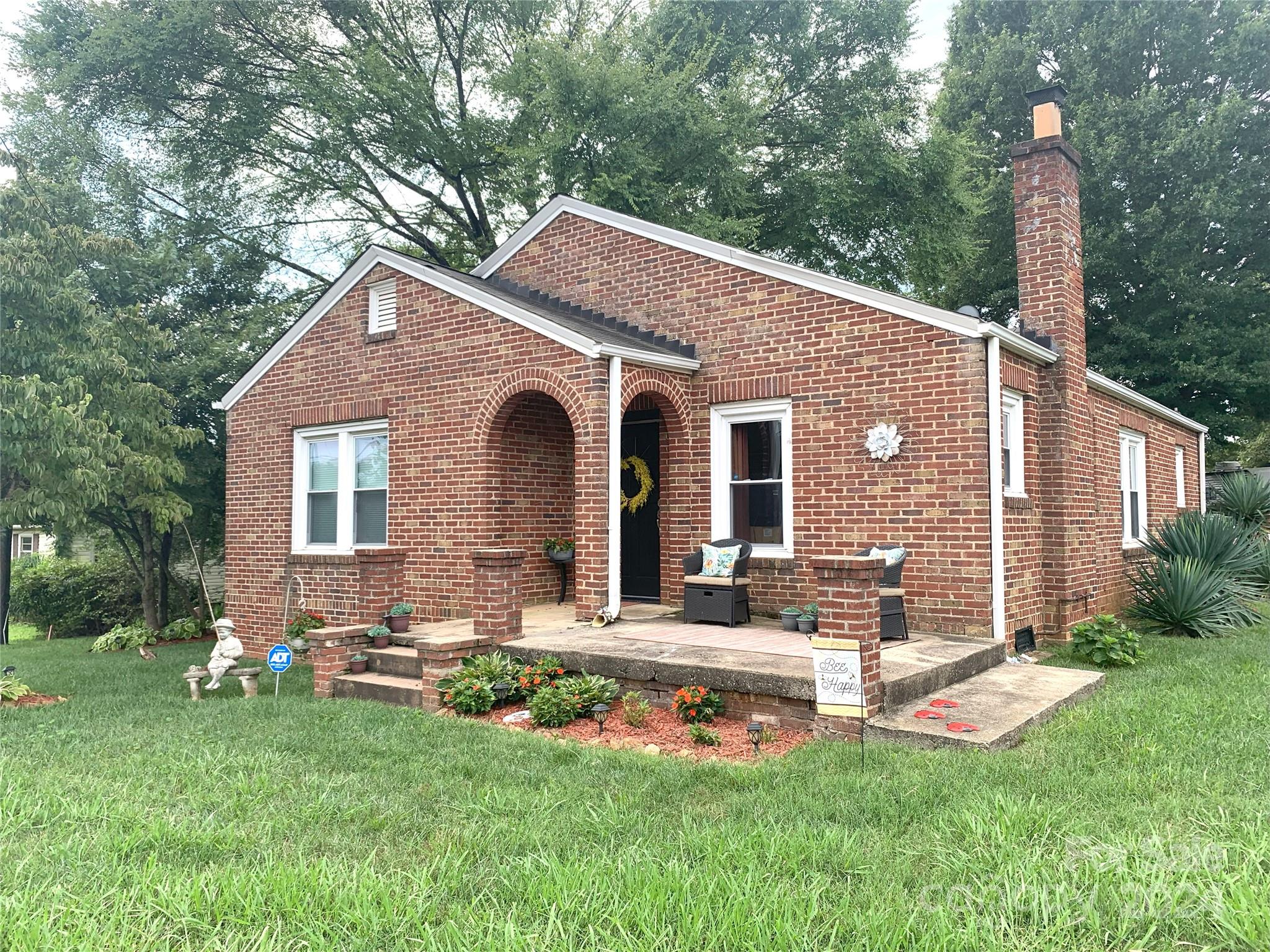 a front view of house with yard and outdoor seating