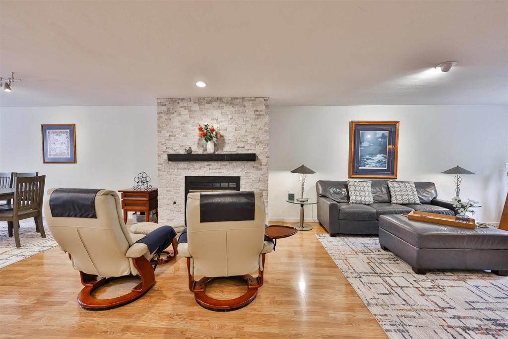 a living room with furniture a rug and a fireplace