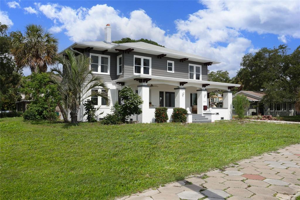 a front view of a house with a garden