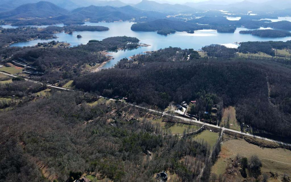 an aerial view of house with yard and mountain view in back