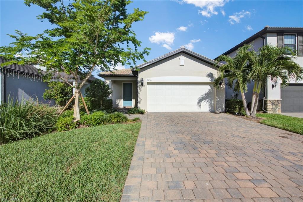 a view of a house with a yard and palm trees