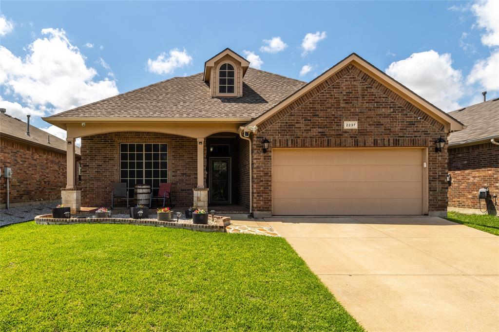 a front view of a house with a yard and seating area