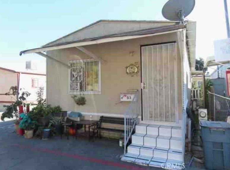 a front view of a house with outdoor seating