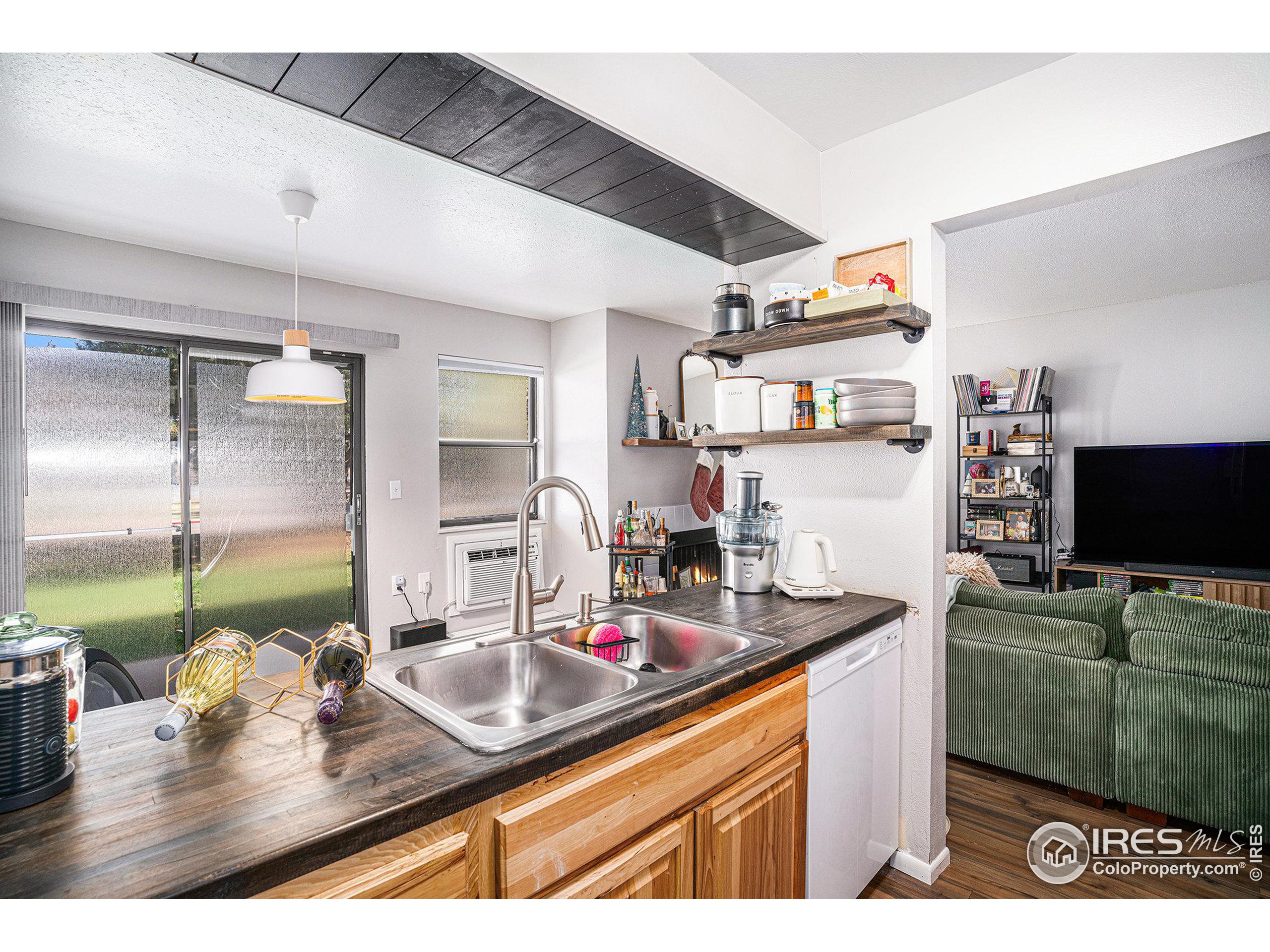 a kitchen with sink a microwave and cabinets