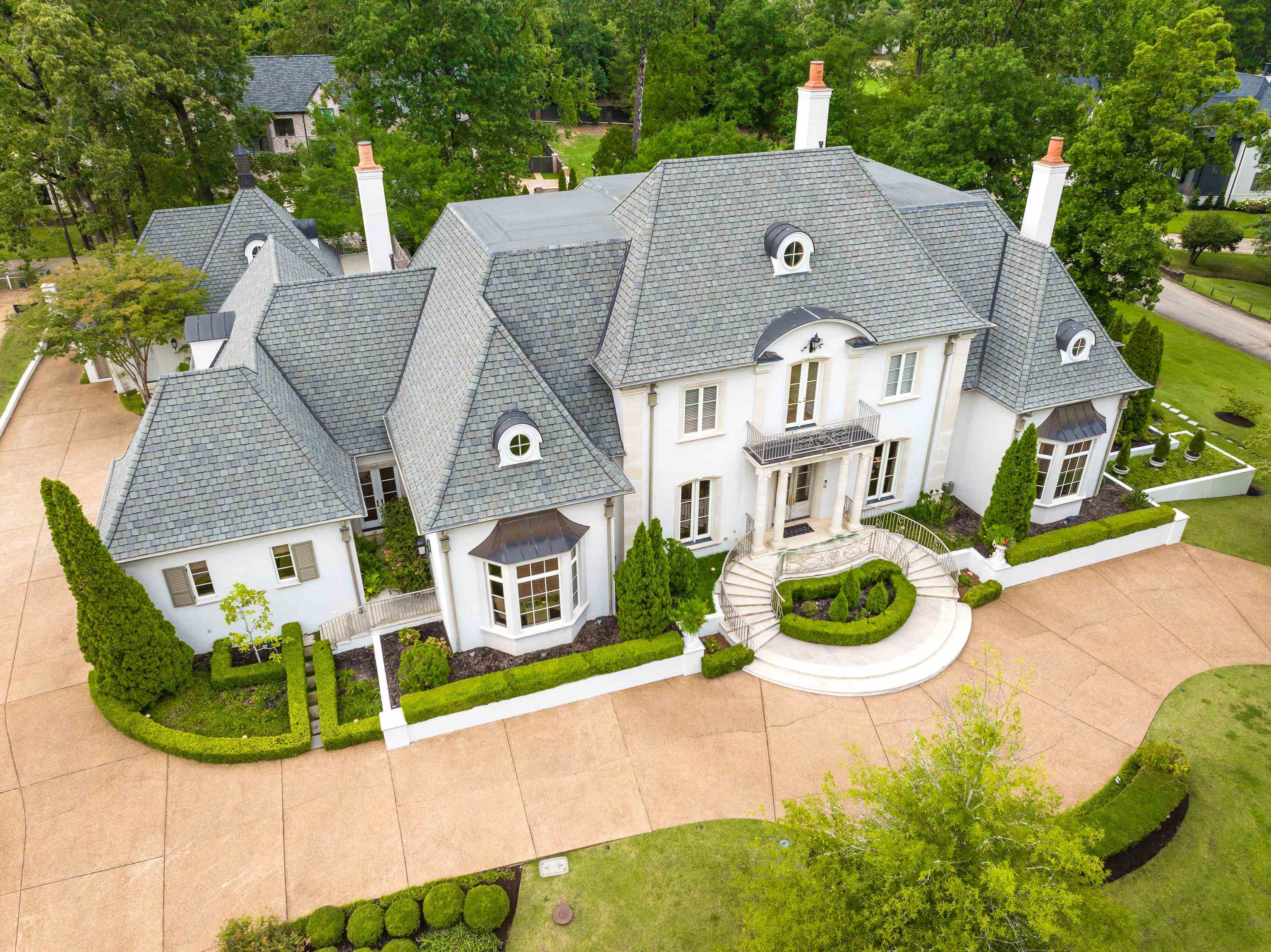 an aerial view of a house with a yard and potted plants