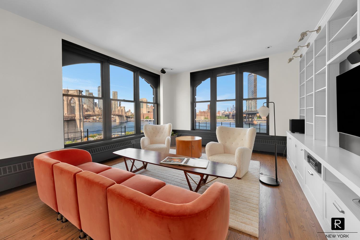 a living room with furniture a flat screen tv and a large window