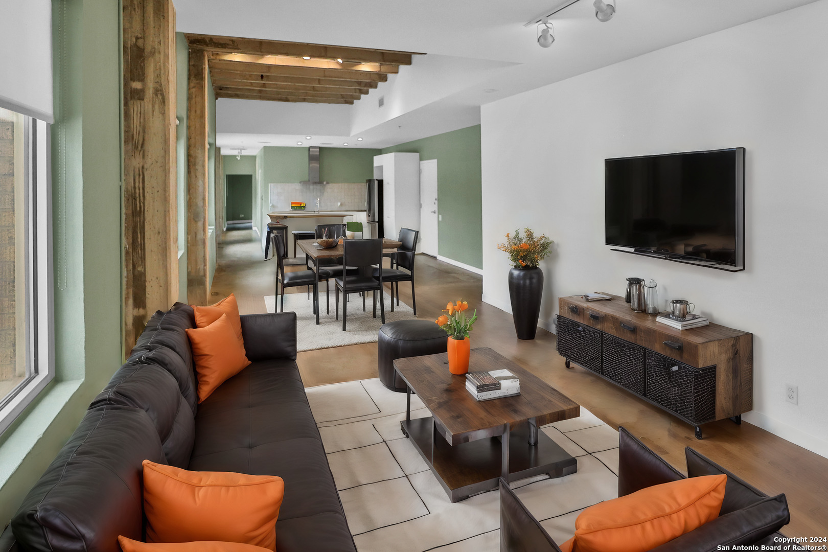 a living room with furniture and a flat screen tv