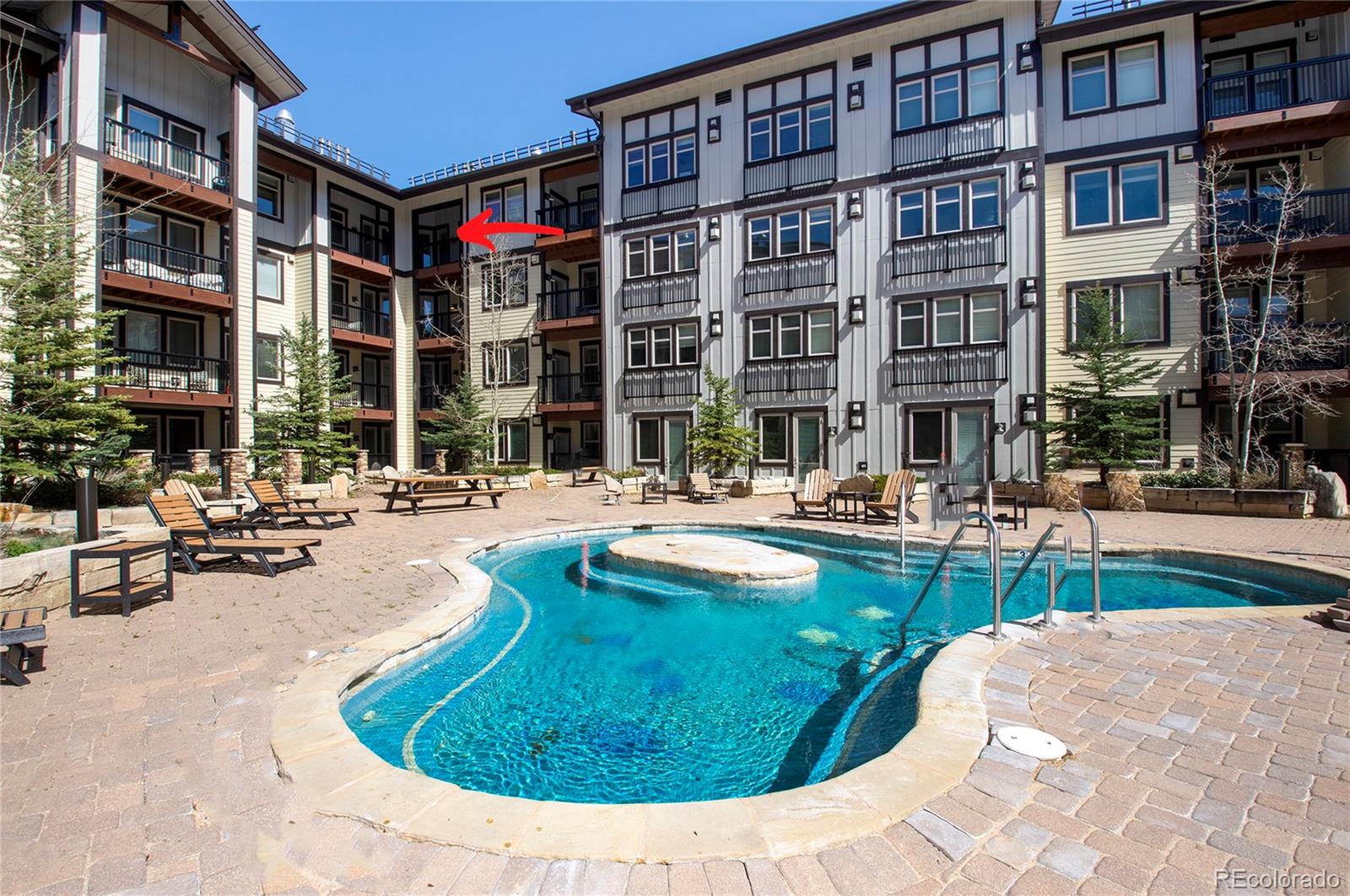 a swimming pool with outdoor seating and yard