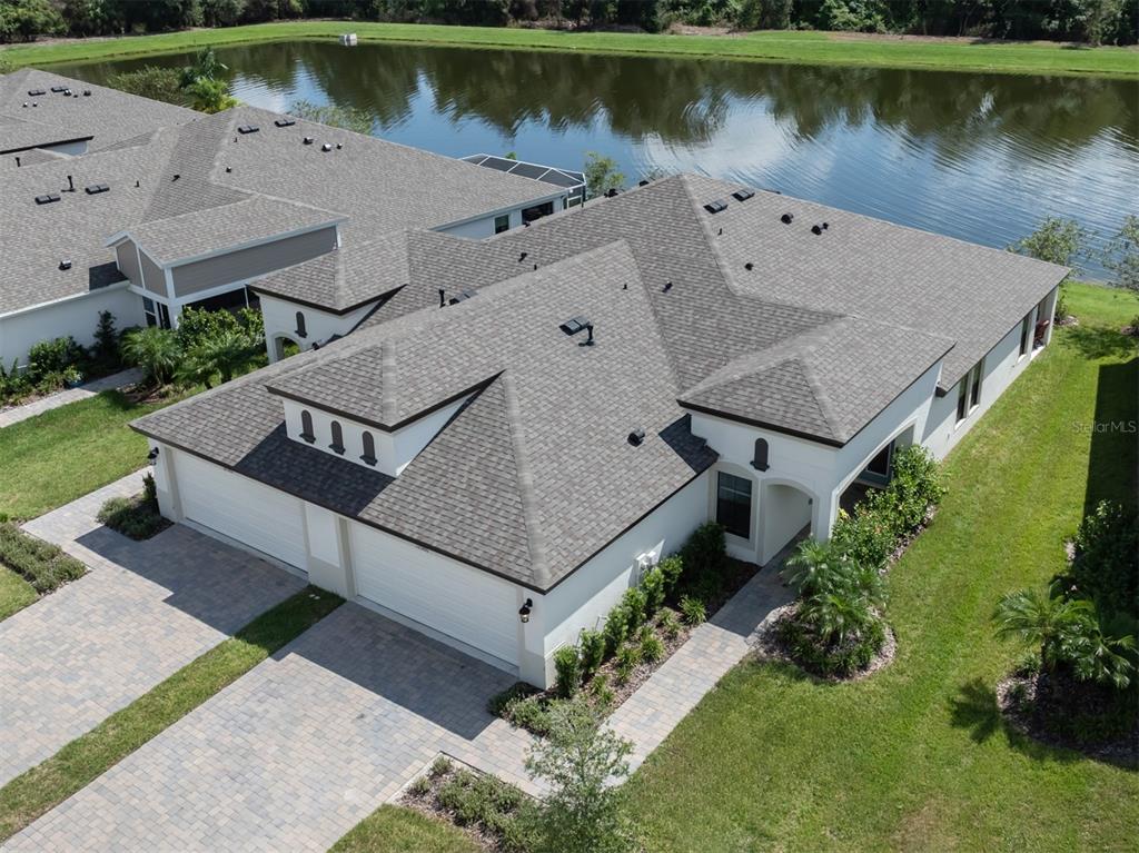 an aerial view of a house with a lake view