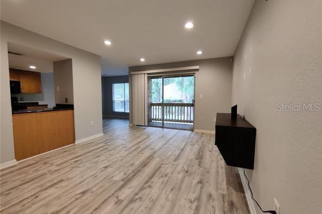 a view of a living room with wooden floor