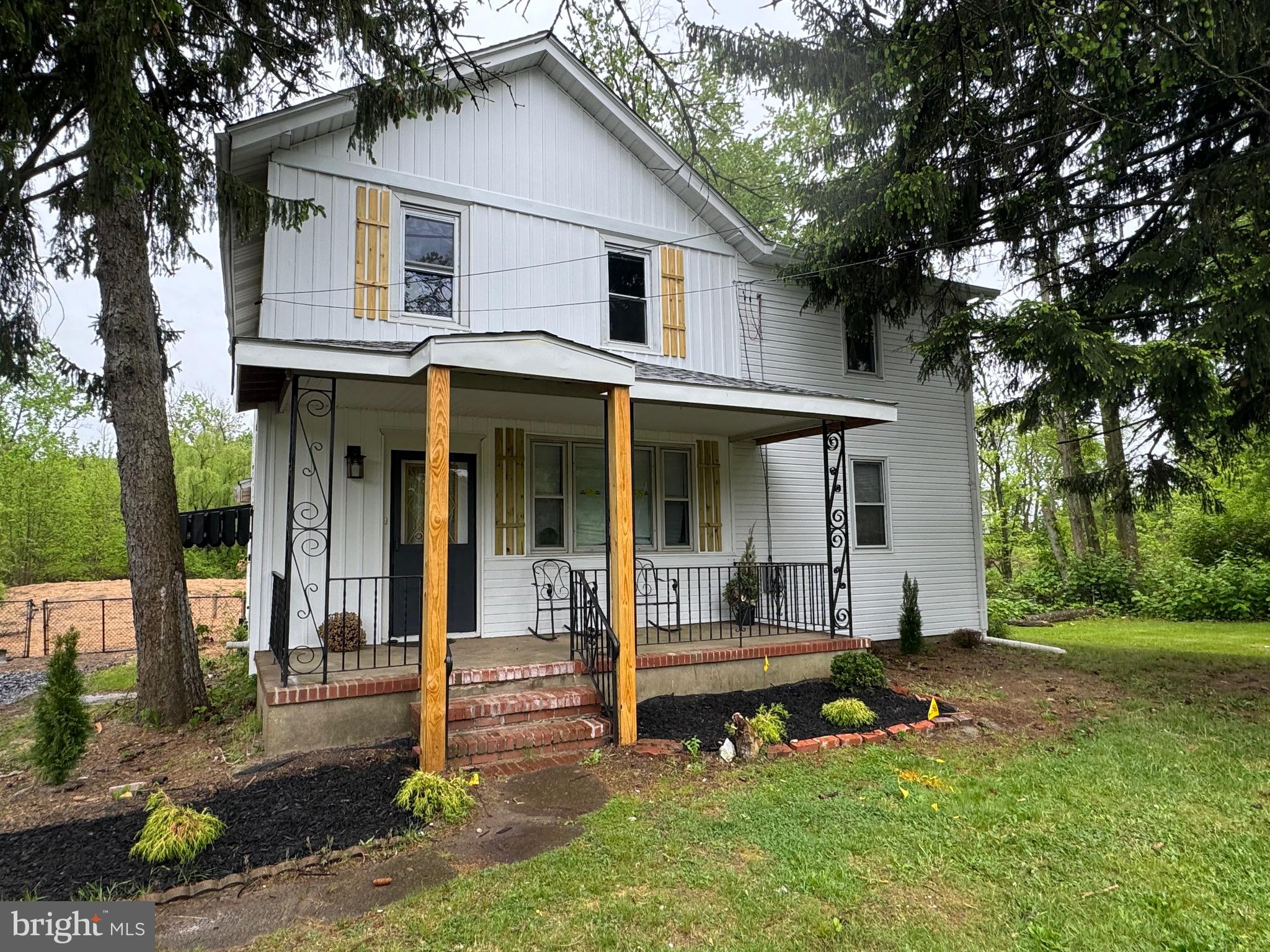 a view of a house with a yard porch and sitting area