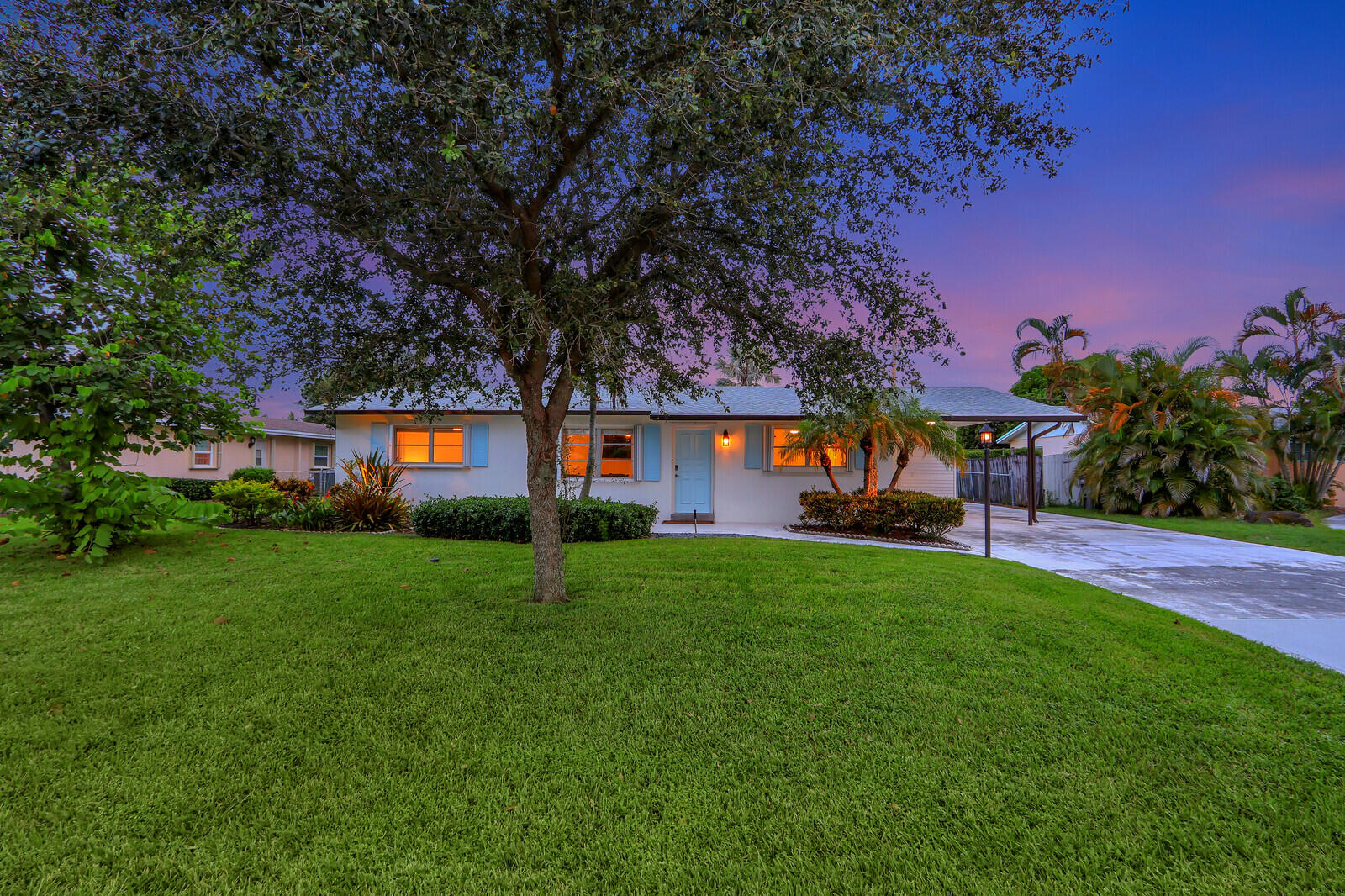 a front view of a house with a yard and a garage