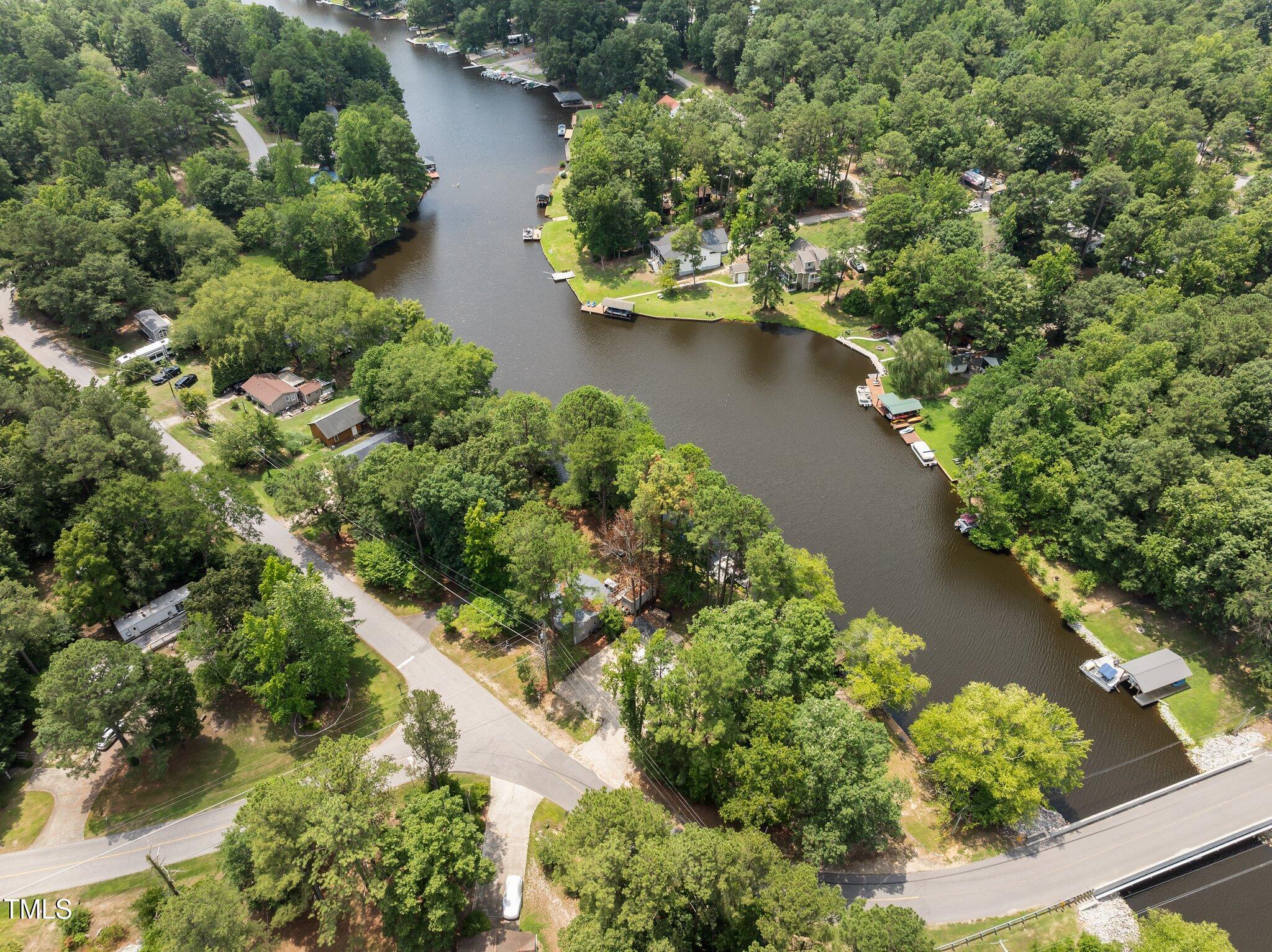 an aerial view of residential house with outdoor space and trees all around