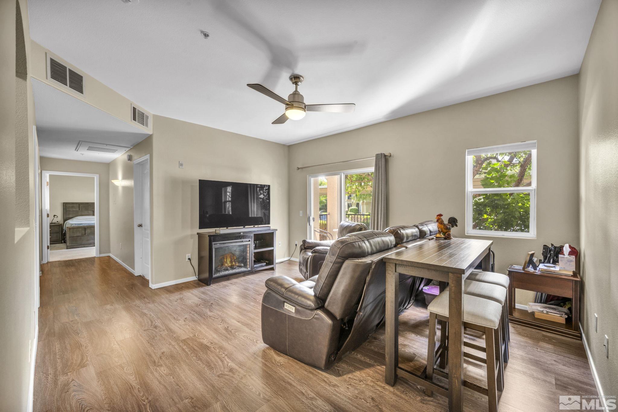 a view of a livingroom with furniture window and wooden floor