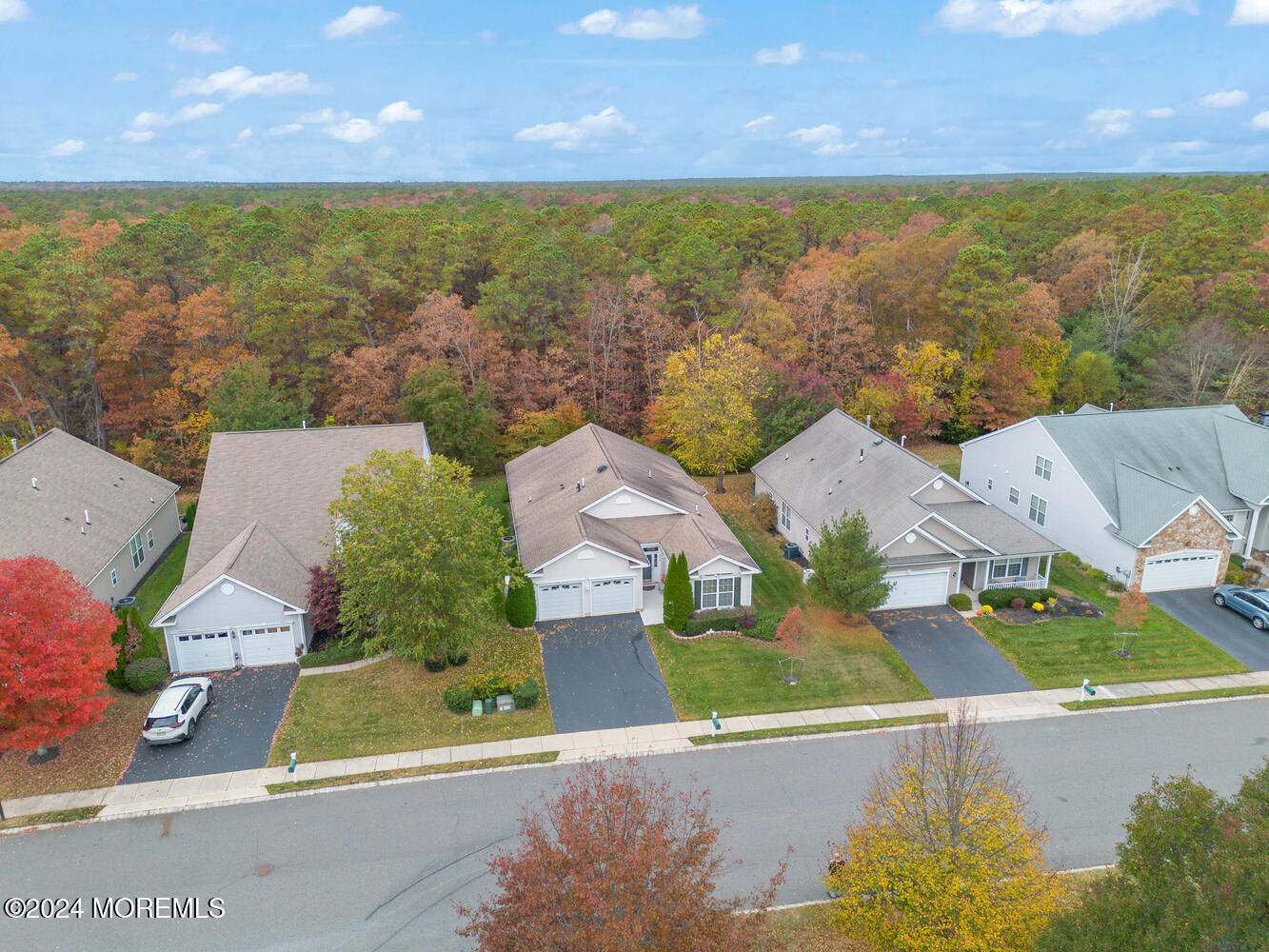 an aerial view of residential houses with outdoor space and a lake view