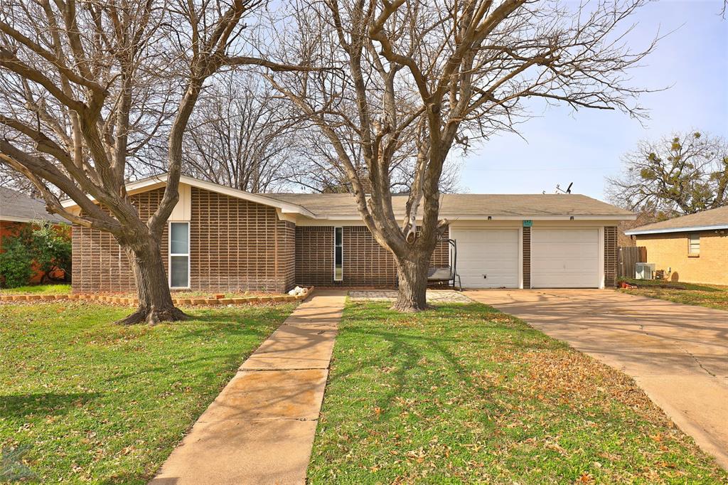 a front view of a house with yard patio and green space