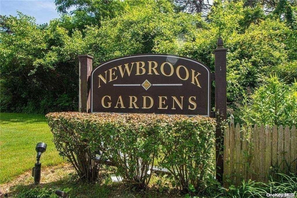 a sign broad in front of the red tree