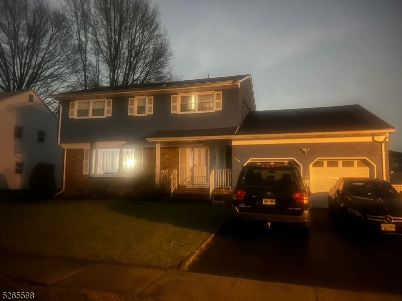 a front view of a house with lots of green space